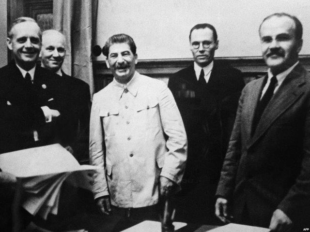 German Foreign Minister Joachim Von Ribbentrop (left), Soviet leader Joseph Stalin, and his Foreign Minister Vyacheslav Molotov (right) in the Kremlin signing the pact dividing Europe between Hitler's and Stalin's regimes on August 23, 1939.