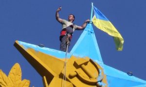 Worker removes Ukrainian. Takes "selfie"