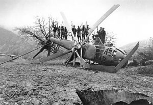 Afghan fighters stand on a downed Soviet helicopter