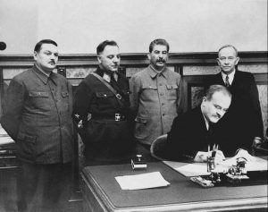 Vyacheslav Molotov signing a deal between the USSR and the Finnish Democratic Republic