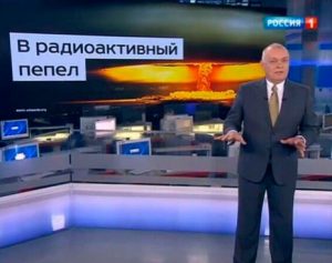 Head of the Kremlin's RT (Russia Today) news agency Dmitry Kiselyov projecting the image of a nuclear mushroom cloud and boasting Russia's ability to turn US "into radioactive dust." RT is the Kremlin's soapbox to promote its policies, denigrate the West and propagate conspiracy theories, as well as attack the political opposition to Putin. (Image: screen capture)