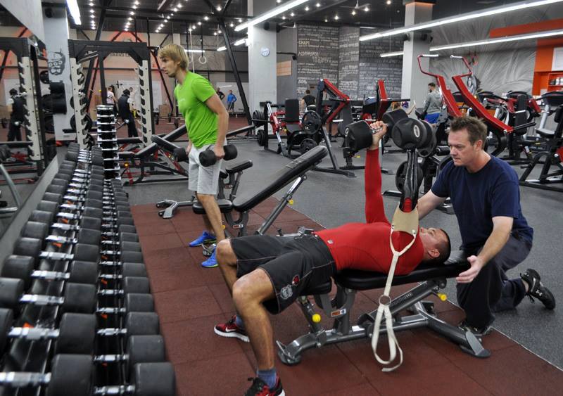 Canadian prosthetist Chad Nilson assists his former patient Vlad at the gym a year after prosthetics. Kyiv, Ukraine, October 2015. Photo provided by Antonina Kumka