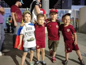Russian children football/soccer fans at the 2016 Euro Cup in France. The t-shirt shows Russia's latest battle tank T-14 "Armata" and sign translating from Russian as: "Clusterf@ck to Everyone!" (Image: social media)
