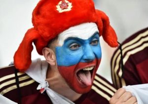 A Russian football/soccer fan making faces while wearing a pseudo-Soviet military fur hat at the 2016 UEFA Euro Cup in France, June 2016 (Image: social media)