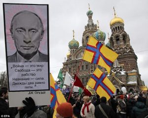 The Putin poster at a demonstration in Moscow quotes George Orwell's "War is Peace, Freedom is Slavery, Ignorance is Strength." (Image: EPA)