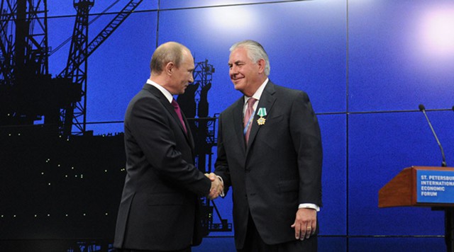 Vladimir Putin salutes Tillerson at the Economic Forum in St.Petersburg in 2013. Photo: Sputnik