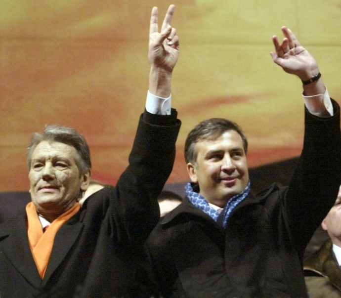Saakashvili stands next to presidential candidate Viktor Yushchenko during the Orange revolution of 2004