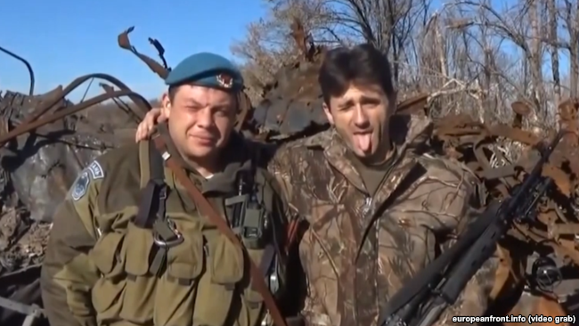 Serbian militant Dejan Beric (right) sends his “greetings” to the government of Serbia