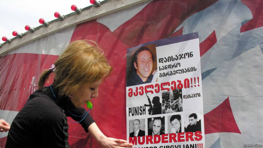 Demonstrators put up posters calling for the punishment of the "murderers of Sandro Girgvliani" at a rally in Tbilisi in April 2006. Photo: InterPressNews