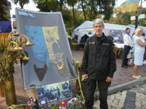 Vadym Mashtabey with battered Ukrainian flag from Donetsk Airport - at the exhibition Checkpoint of Remembrance