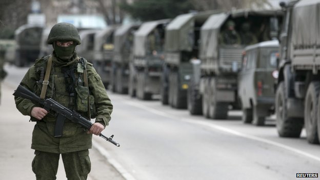 Unmarked trucks with Putin's so-called "little green men" - heavily-armed Russian cadres military troops hiding their identities and without insignia during the invasion into the Ukrainian peninsula of Crimea in February 2014.