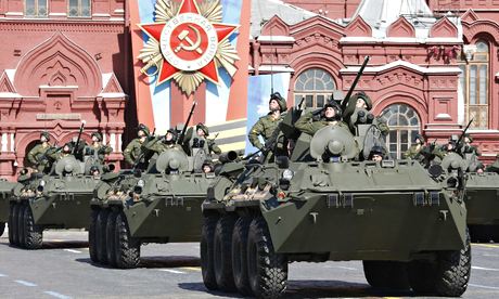 Troops in armoured personnel carriers salute during the Victory Day parade. Photograph: Grigory Dukor/Reuters