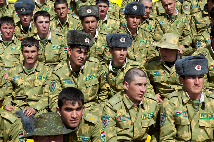 Young Tajik soldiers watch a wrestling match during Novruz celebrations in late March in the capital Dushanbe. The recent shortage of conscripts due to labor migration and evasion in the face of harsh conditions has led to impressment, the quasi-legal kidnapping of military-age men. (Photo: David Trilling, eurasianet.org)