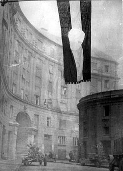 Flag of Hungary, with the communist coat of arms cut out. The flag with a hole became the symbol of the revolution. Budapest, 1956 (Photographed at the "Corvin köz")