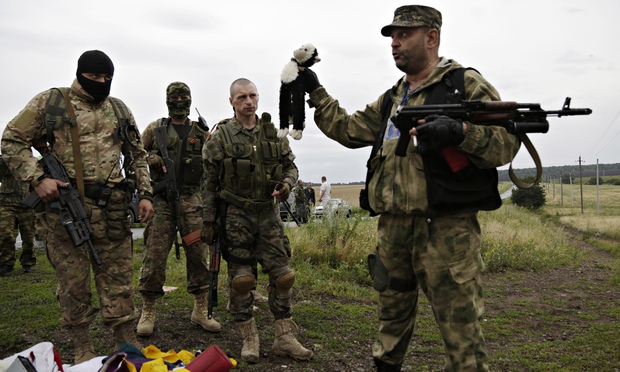 Russian mercenaries taking photographs with personal items found among the debris at the crash site of MH17 downed by a Russian BUK surface-to-air missile in Russia-occupied east Ukraine