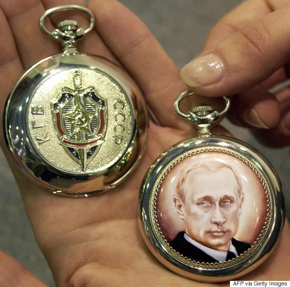 MOSCOW, RUSSIA: A woman displays gold watches with Russian President Vladimir Putin's picture and the writing "KGB of the USSR" (L). (Image: MAXIM KONIAYEV/AFP/Getty Images)
