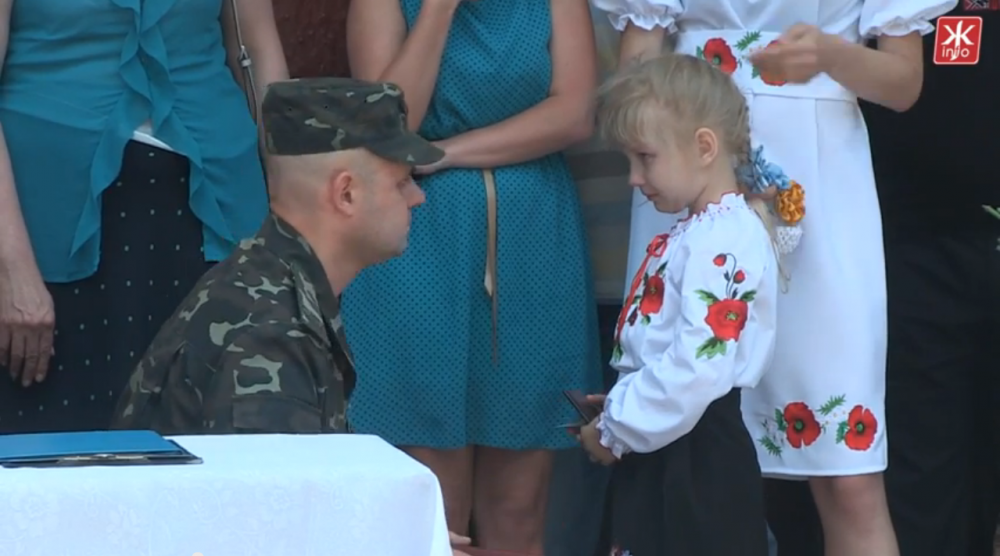 The daughter of a Ukrainian soldier from Zhytomyr receives an Order "For Courage" awarded to him posthumously, June 2015. (Photo: zhitomir.info)