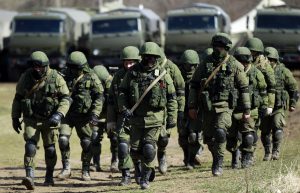 Russian "green men" occupation force surrounding a Ukrainian military base in Perevalne, Crimea, in March 2014.