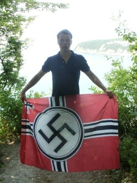 Russian neo-Nazi Alexey Milchakov with a Nazist swastika flag (Image: Milchakov's social network page)