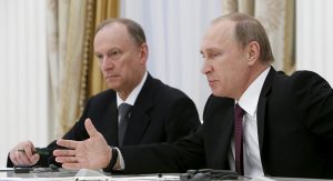 Russian President Vladimir Putin (R) and Presidential Aide Nikolai Patrushev