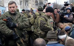 Leader of the self-declared Donetsk People's Republic Alexander Zakharchenko stands next to kneeling captive Ukrainian soldiers