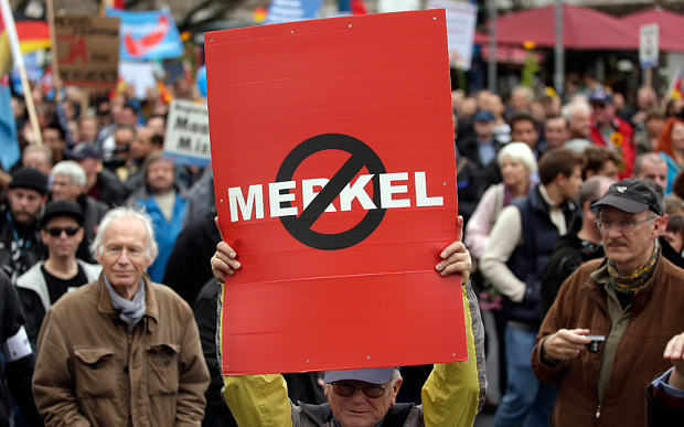 People take part in a protest rally of the German party 'Alternative fuer Deutschland, AfD' (Alternative for Germany) in Berlin. The anti-immigration party staged a march in Berlin against the German government’s migrant policies, with demonstrators chanting “Merkel must go” Photo: AP