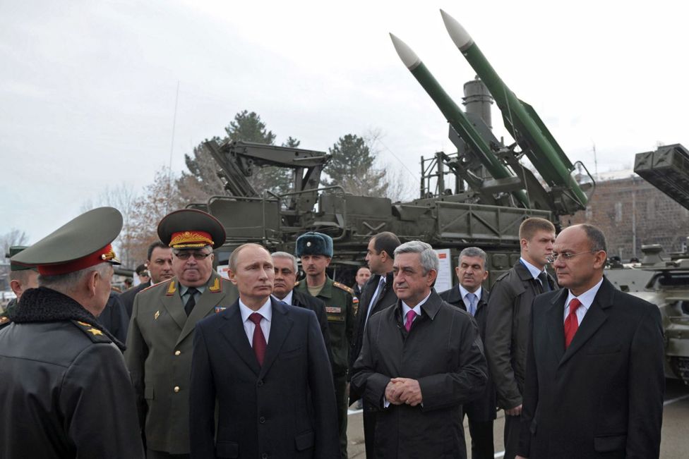 Vladimir Putin in 2013 standing in front of a Buk missile launcher similar to one used to shoot down the Flight MH17 a year later (source: BBC MH17 Documentary)