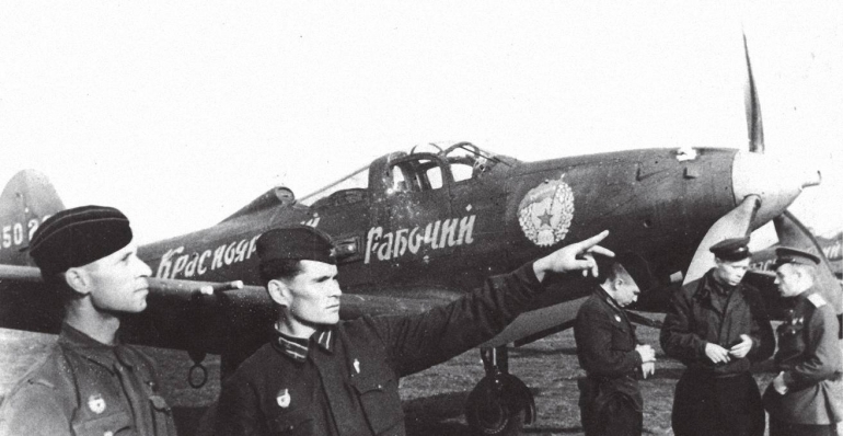 Pilots of the 21st Guards Fighter Aviation Regiment stand near the American fighter plane P-39 “Aircobra”, May 1943 ~