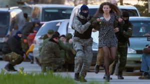 Russian special forces and mercenaries subdue and escort away a local resident before Russian troops assault the Ukrainian Belbek airbase, outside Sevastopol, Crimea, on March 22, 2014. (Image: AP Photo/Ivan Sekretarev)