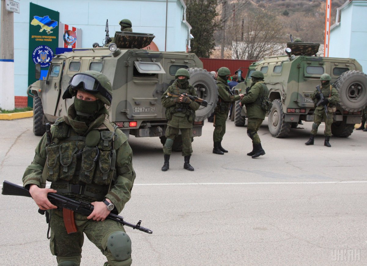 At first, Putin claimed there were the “little green men” in Crimea, not the Russian military, as he admitted a year later. Russian special services troops besieging a Ukrainian military base in Crimea, February 2014. (Image: UNIAN)