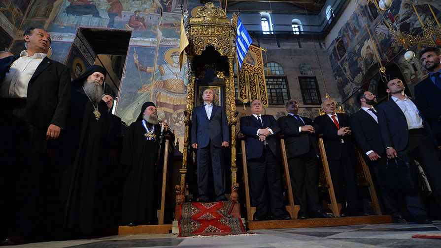 Vladimir Putin visiting Karyes, the Orthodox enclave of Mount Athos in May 2016. The above photo, of Putin standing at an ancient throne alongside Greek officials and Orthodox dignitaries, was described by various Russian news outlets, both within the country and abroad, as Putin standing at a place which had until then been reserved only for Byzantine emperors.