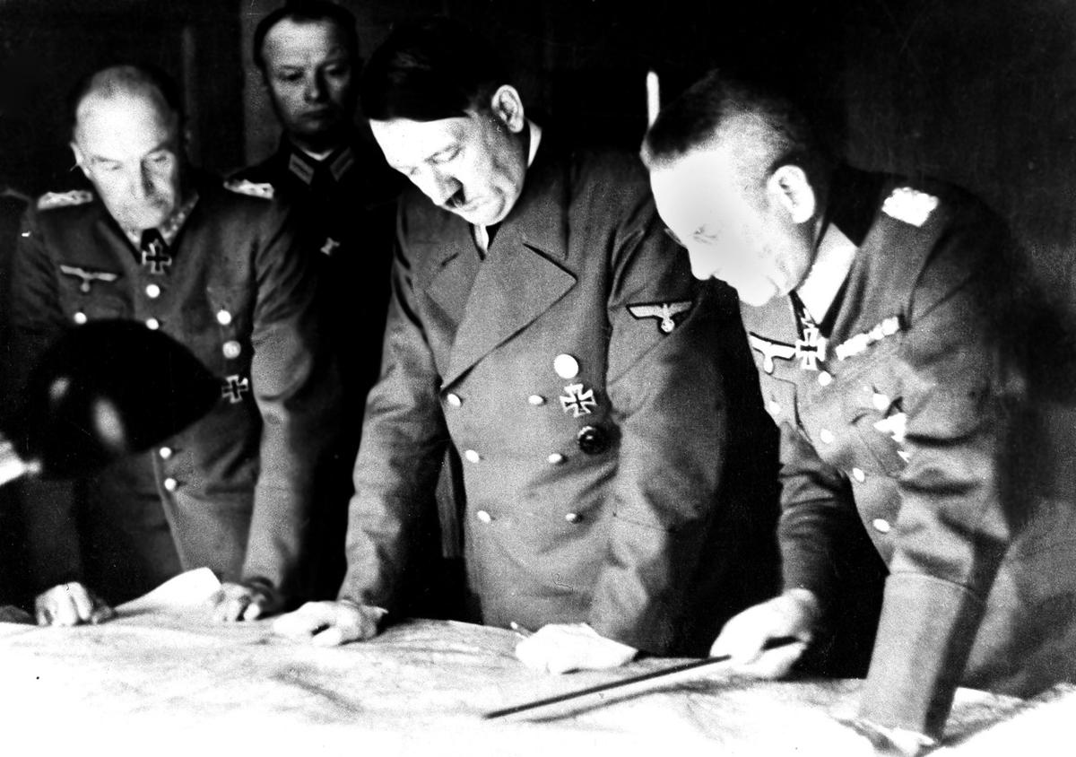 Adolf Hitler, center, studies a USSR war map with General Field Marshal Walter Von Brauchitsch, left, German commander in chief, and Chief of Staff Col. General Franz Halder, on August 7, 1941. (Image: AP)
