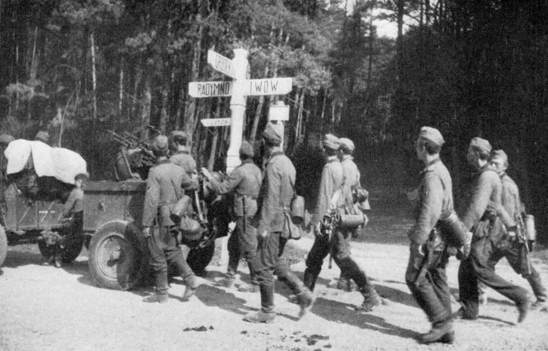 Invading German troops marching past a road sign near Lviv, 1939