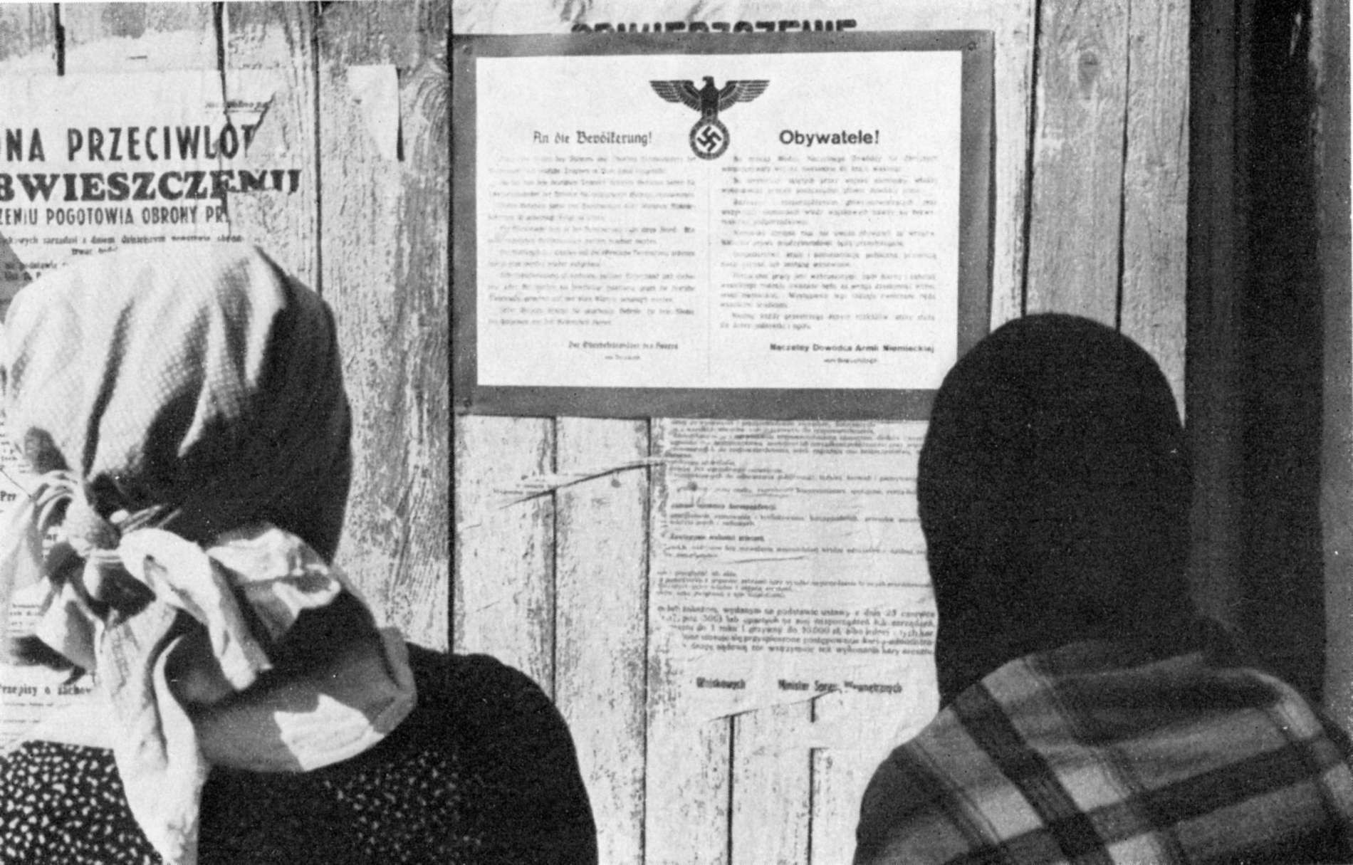 Polish women reading public orders of the German occupation force, September 1939