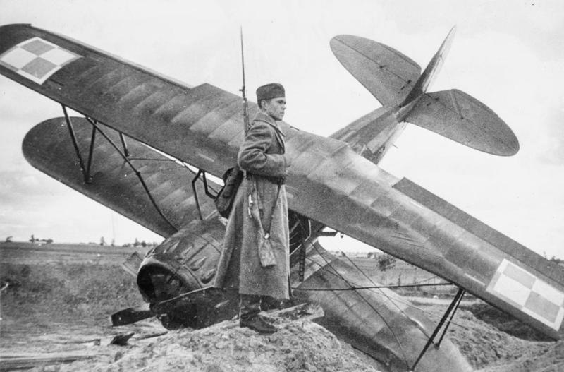 Soldier of the invading Soviet army guarding a Polish fighter airplane downed by the German air force, Sept. 17, 1939