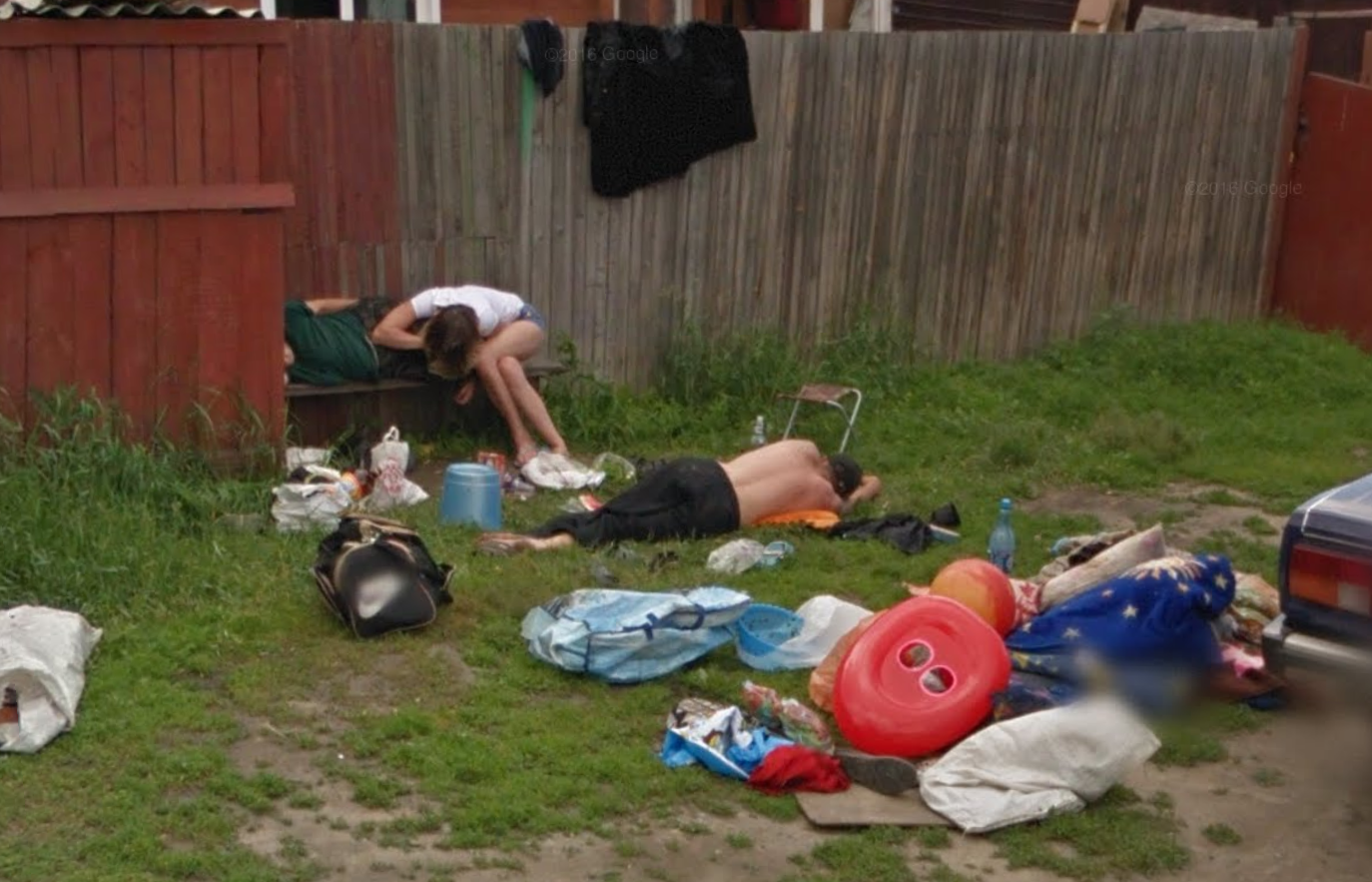 In an image recorded back in 2013, Google photographed a family of three in Russian city of Novoaltaysk, collapsed outside in a heap of garbage and lawn furniture. In the picture, bottles and grocery bags are strewn about the yard, and two of the people are piled on top of each other. (Image: Google via The Moscow Times)
