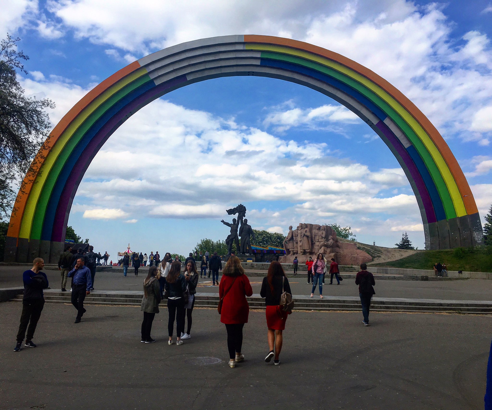 The Friendship of Nations Arch, an old Soviet monument in Kyiv, painted as a rainbow for the 2017 Eurovision Song Contest. The painting is unfinished to symbolize Ukraine's incomplete liberation from Russia. (Image: @DaveKeating via Twitter)