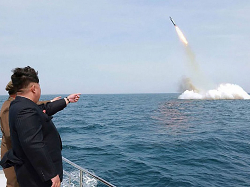 Kim Jong Un, the "Supreme Leader" of North Korea, supervises the April 22 test-launch of a missile from a submerged platform. (Image source: KCNA)