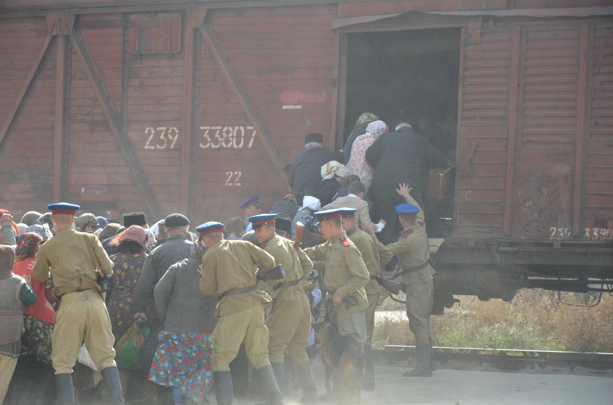 NKVD soldiers drive Crimean Tatar women, children, and elderly to the cattle wagons. Snapshot from the film