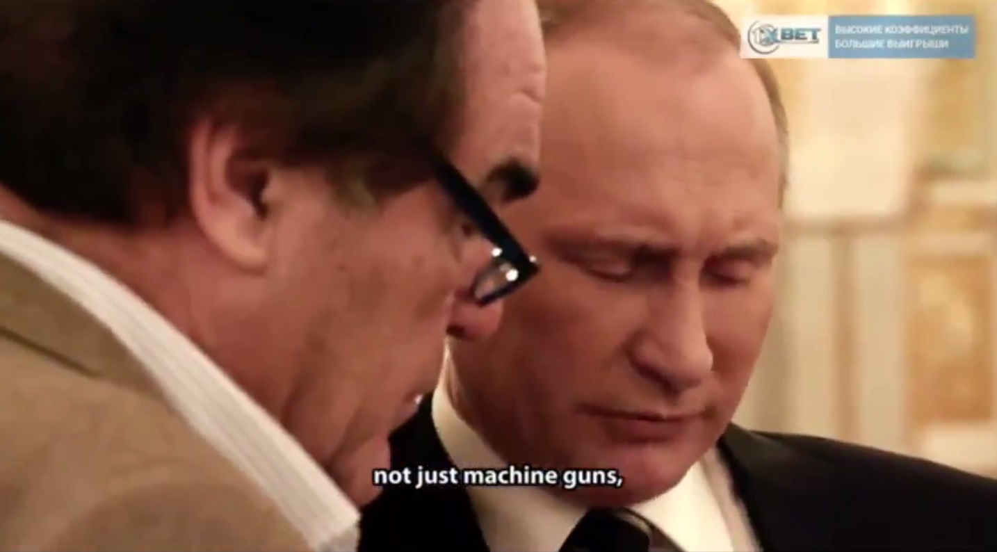 Russian president Vladimir Putin and cinematographer Oliver Stone at the Kremlin in 2017. Putin shows Stone fake footage of a "Russian helicopter bombing ISIS," which in actuality was footage of U.S. forces fighting the Taliban in Afghanistan in 2013 (Image: video capture)