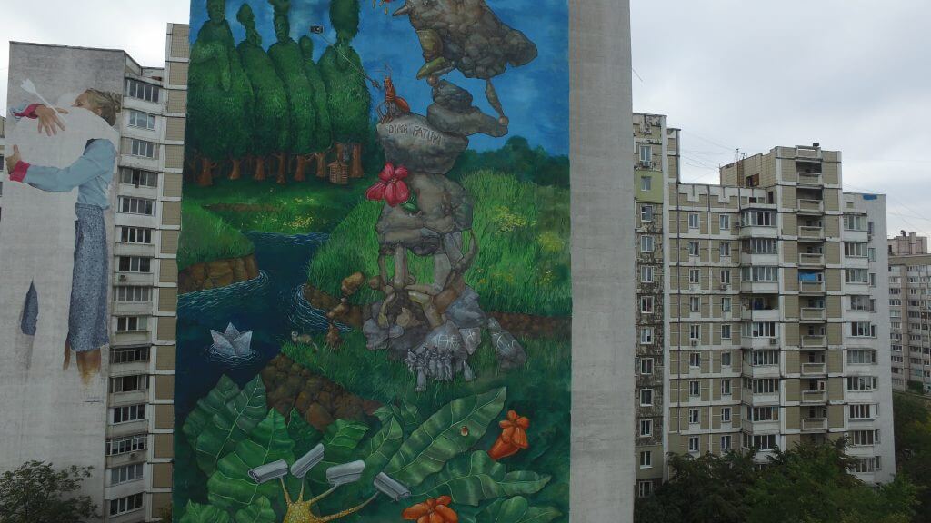 Author: Dima Fatum The huge wall tells a surreal picture-story about the historical and contemporary context of the Kharkiv neighbourhood, the second-largest city in Ukraine. The composition is filled with a variety of Ukrainian traditional characters, each of which illustrates this area. 