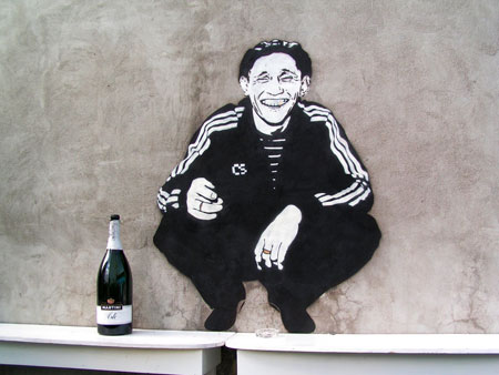 A "gopnik," featured in this street art, embodied the gangster culture of the 90's