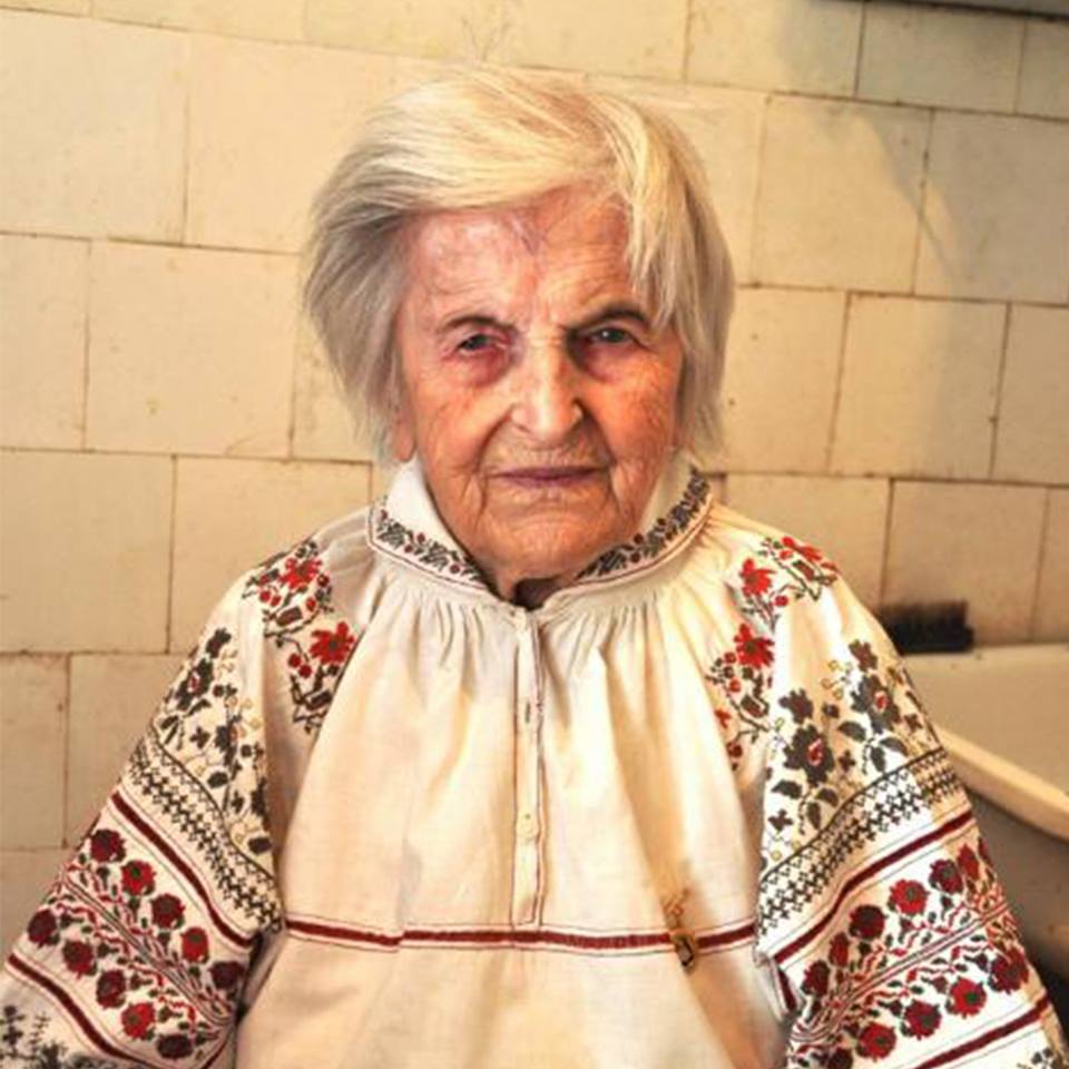 Olha Ilkiv wearing the embroidered shirt she sewed in prison from prison sheets. She treasures this memento and wears it only on important holidays and celebrations. 
