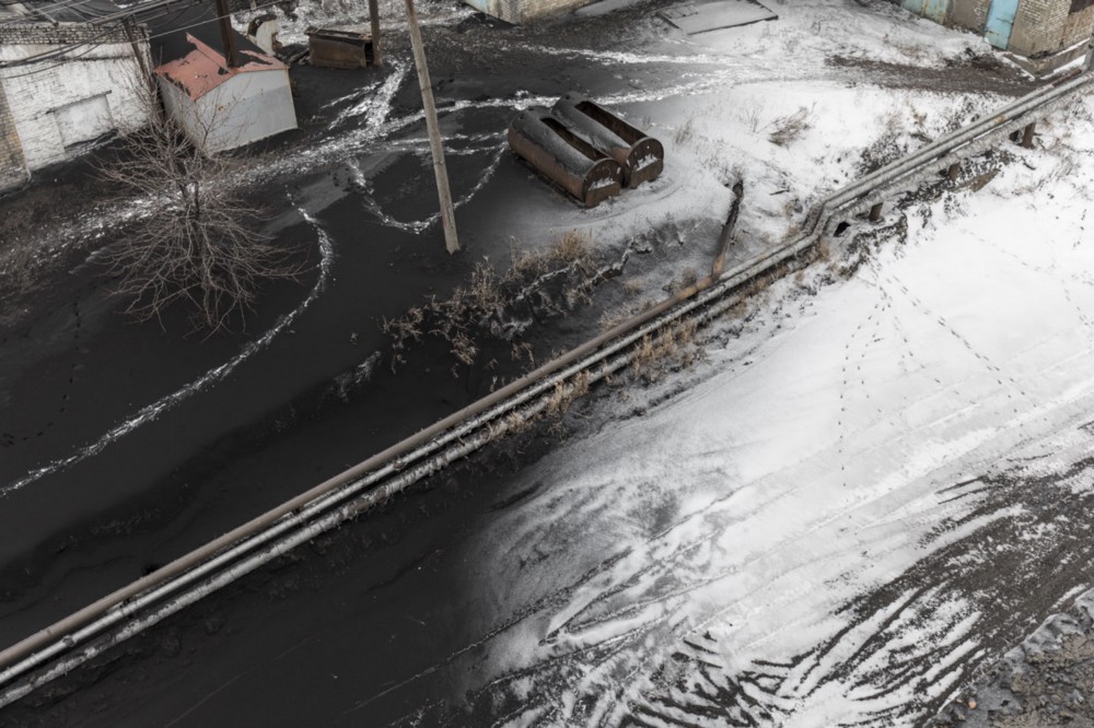 Snow is covered by a layer of soot in a mining station in Donbas
