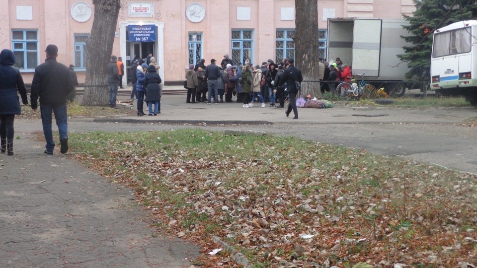 At first look, it may seem that a small crowd is going to vote, but this actually is a queue to buy cheap products near the polling station. Yasynuvata, Donetsk Oblast, 11 November 2018. ~