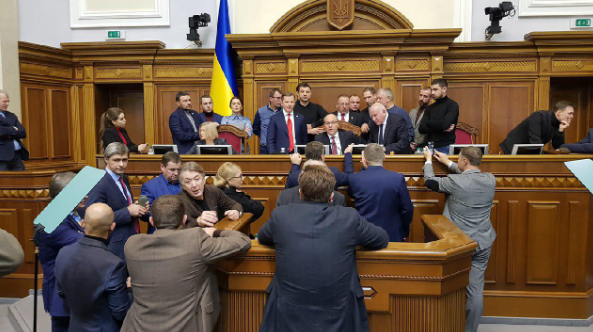 Ukrainian MPs blocked the rostrum of the Parliament prior to the vote for imposing martial law. The most discussed questions are the fate of the upcoming presidential elections and the territory where martial law will be enacted. Photo: 112.ua ~
