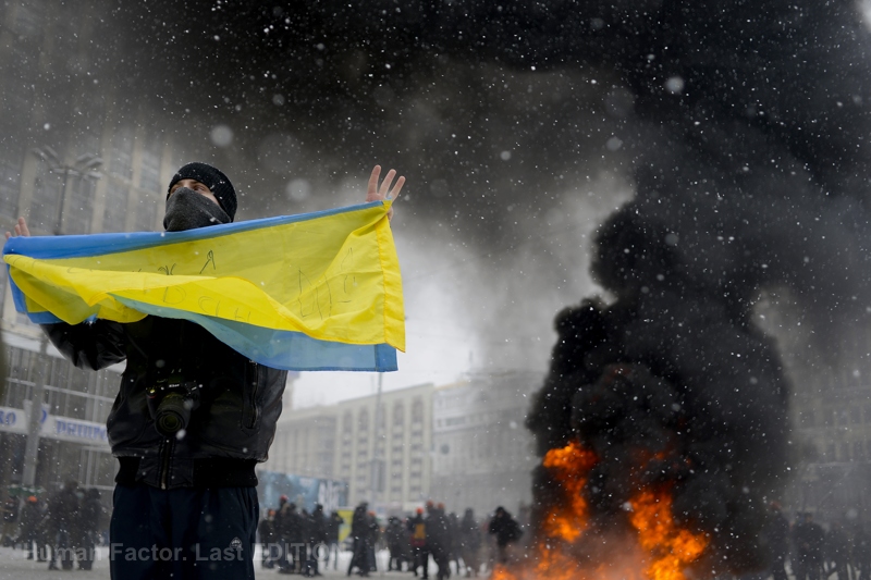 A man holds a Ukrainian flag amid the Euromaidan protests in central Kyiv. Photo: Maks Levin. 22 January 2014. From the project Human Factor: Last Edition ~