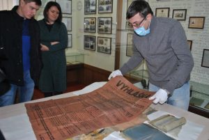 Ruslan Zabily, Director of the National Memorial Museum “Tiurma na Lontskoho”, examines findings ~