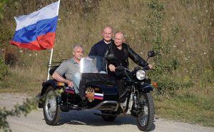 Vladimir Putin riding a three-wheel motorcycle in occupied Crimea with the head of the Russian occupation administration of Crimea Sergey Aksyonov and the acting mayor of Sevastopol Mikhail Razvozhayev (L-R) on August 10, 2019. Photo: kremlin.ru