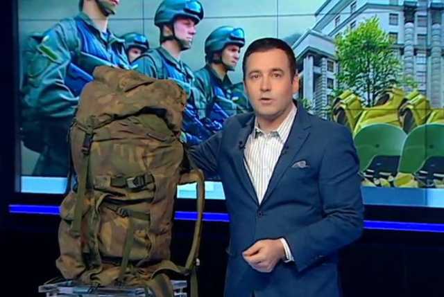 A presenter displays a rucksack which the Ukrainian state bought at 0 each An expertise determined they cost  to sew; Avakov’s son is determined to have profited from the deal ~